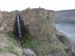 A waterfall runs down the basalt cliff into LBC.